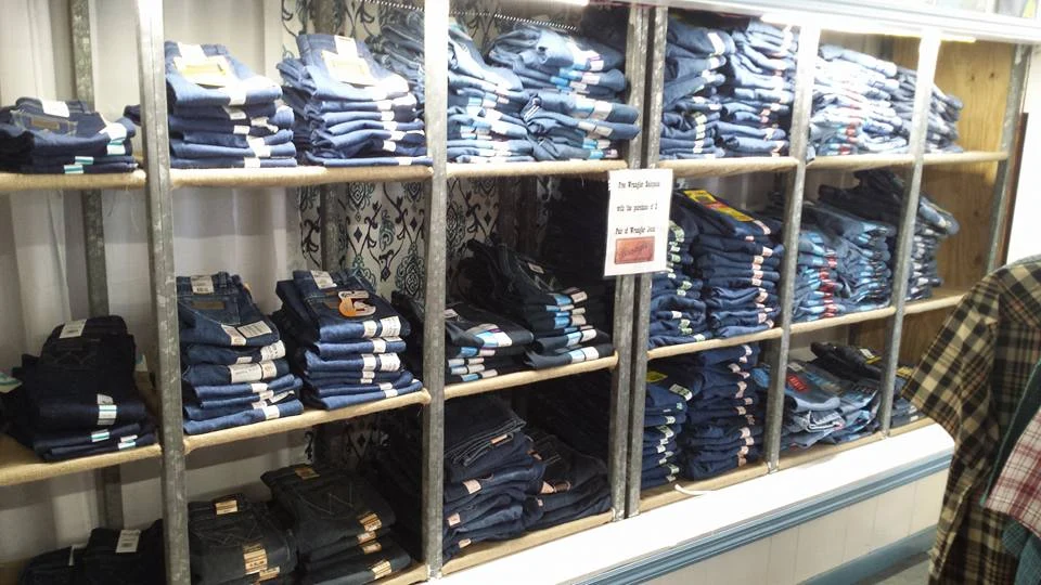 Shelves of workwear and blue jeans at Baker Feed.